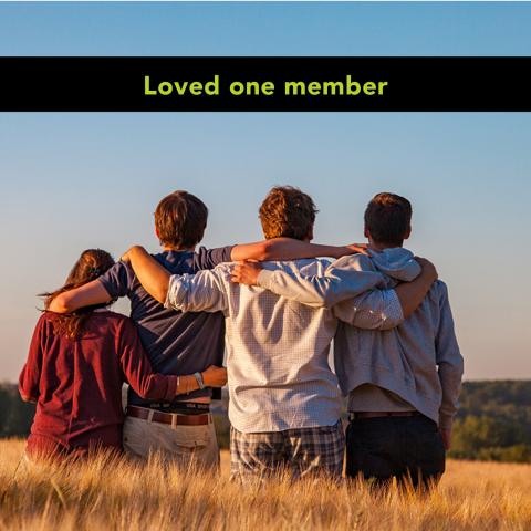 Photo of family standing arm-in-arm in field