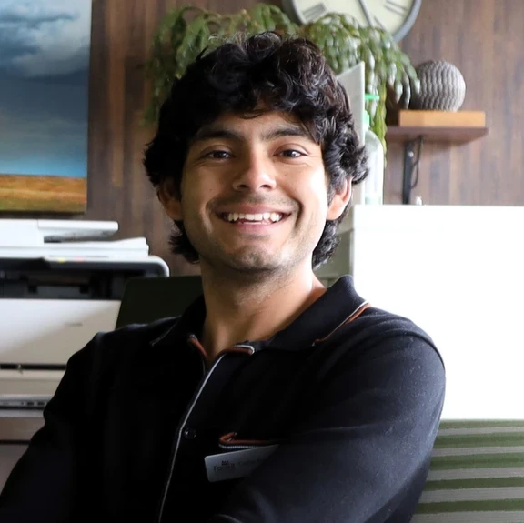 Photo of young man smiling in office