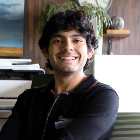 Photo of young man smiling in office