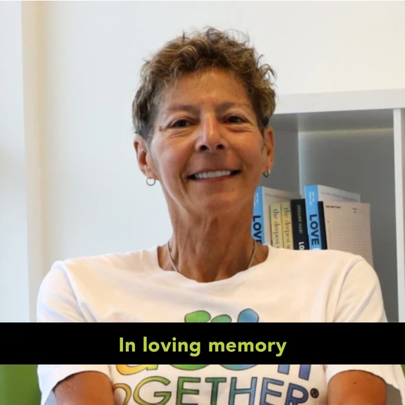 Photo of woman with short, curly hair and "in loving memory" text at the bottom