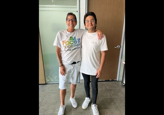 Photo of Terri and Carlos smiling in the office